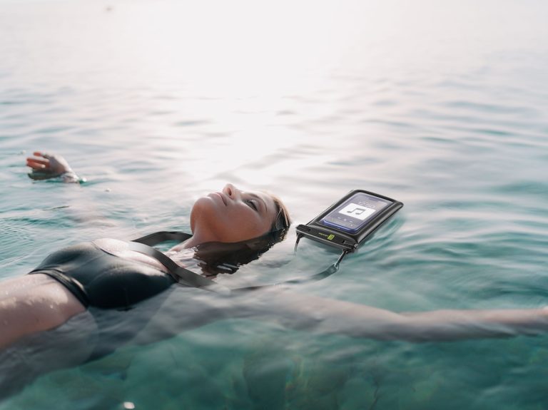 Photo of a young woman relaxing and cooling off in the ocean on a hot summer afternoon